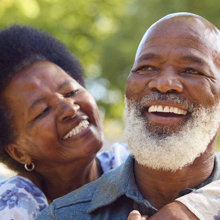 Smiling senior couple embracing outdoors, representing Legacy Giving and lasting Hope through 6 Stones