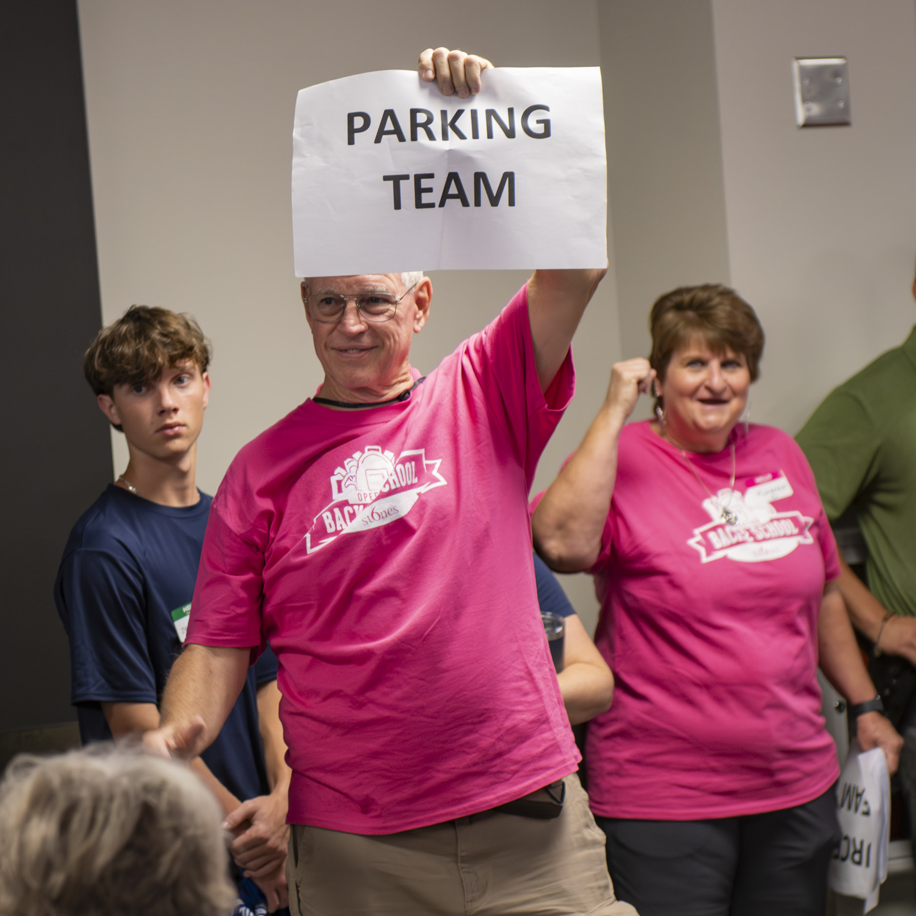 Parking team volunteer helps direct guests at Operation Back 2 School.