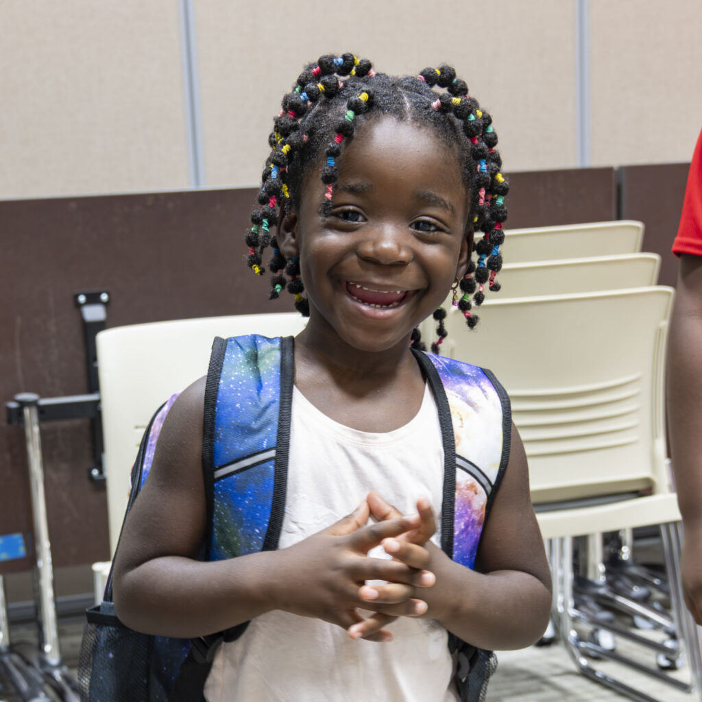 Smiling student wearing a backpack at Operation Back 2 School.