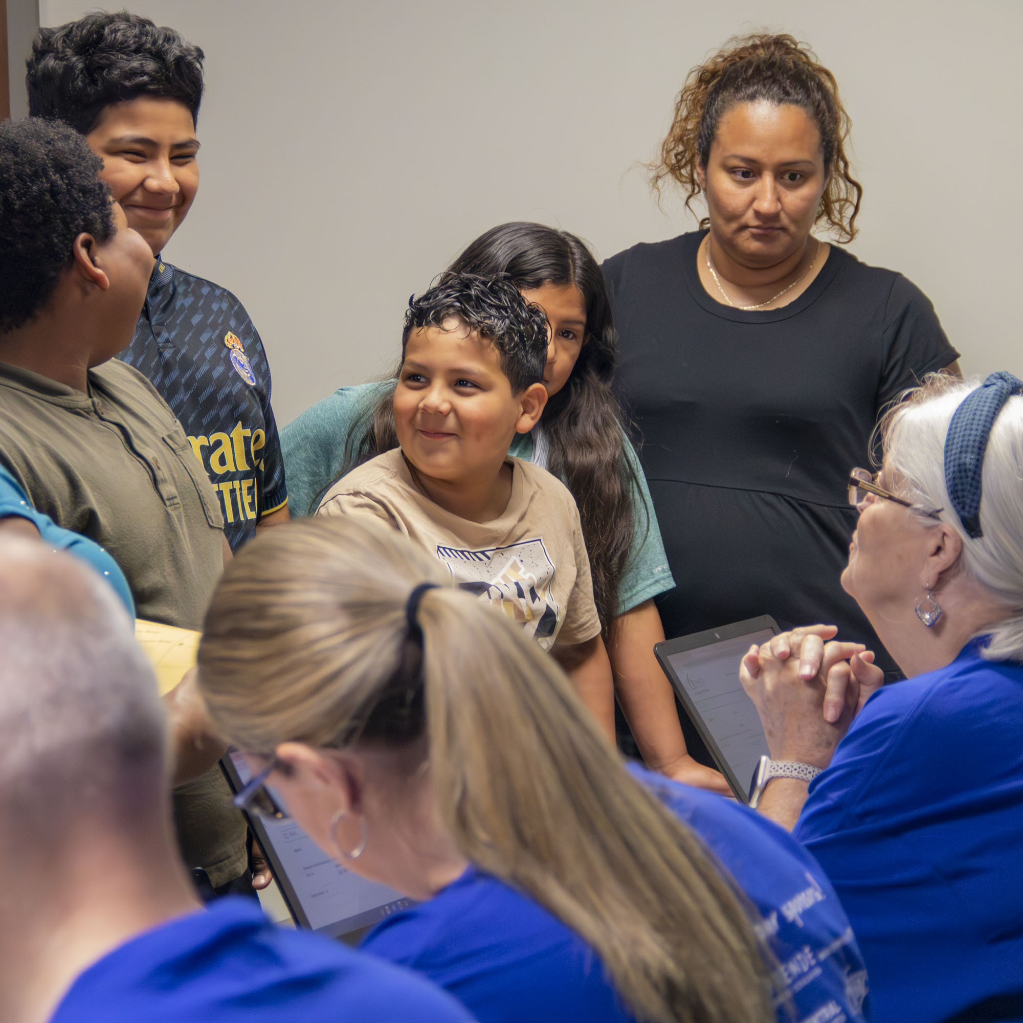 Volunteer checks in a family at Operation Back 2 School.