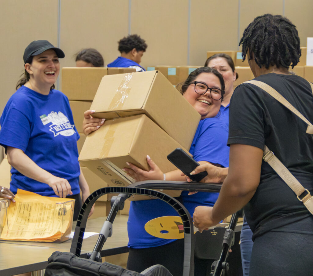 Volunteers distribute school supply kits at Operation Back 2 School.