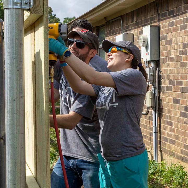 6 Stones volunteers work together on a home repair project.