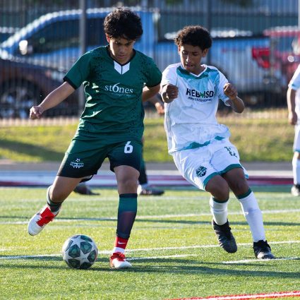 Liga HEB junior high soccer players compete for the ball during a game